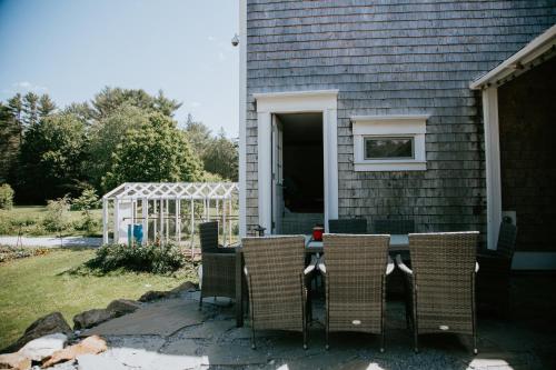a patio with a table and chairs in front of a house at Family Farmhouse in Union