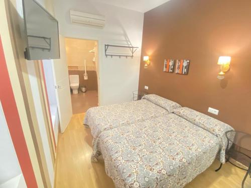 Ένα ή περισσότερα κρεβάτια σε δωμάτιο στο Hostal Fabiola