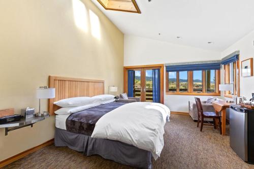 a bedroom with a large bed and a desk and chair at Costanoa in Pescadero