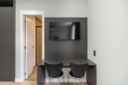 a dining room with a table and two chairs at TCO - Apartamentos no Centro Histórico Porto Alegre/RS in Porto Alegre
