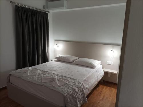 a bedroom with a large bed with two pillows at Euphemia's Apartment in Ampavris