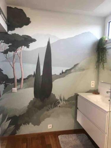 a wall with a mural of trees and plants at Kot é Vert g in Huy