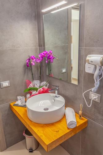 a bathroom with a sink and a mirror at Isgrò Rooms in Marsala