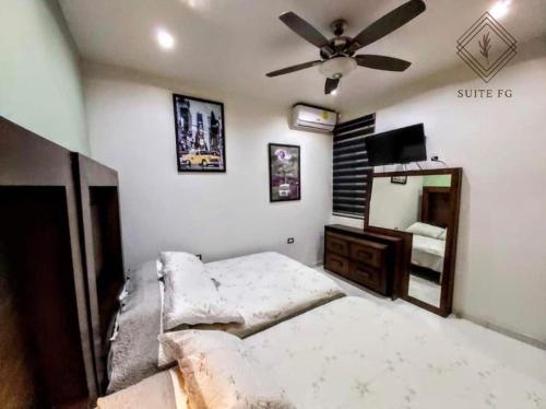 a bedroom with a bed and a ceiling fan at Suite FG in San Juan de los Lagos