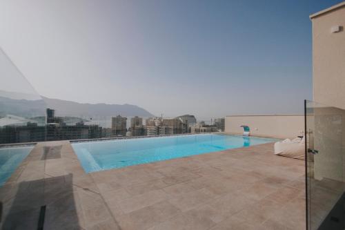 a swimming pool on the roof of a building at Infinity Hotel & More in Budva
