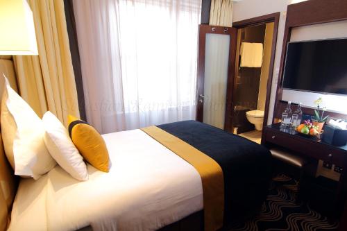 a hotel room with a bed and a television at Montcalm Piccadilly Townhouse, London West End in London