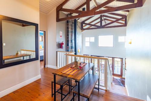a dining room with a table and a mirror at Peak's Cabin - Endless Ocean Views - Fireplace - Fast WiFi in Wilderness