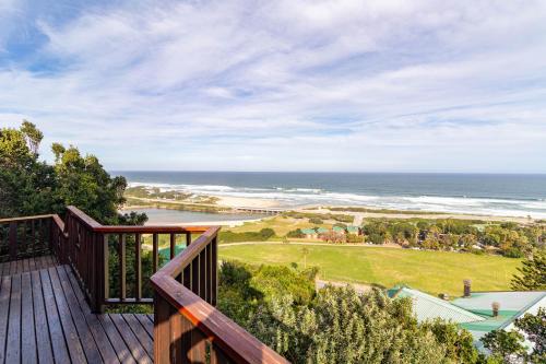 a deck with a view of the ocean at Peak's Cabin - Endless Ocean Views - Fireplace - Fast WiFi in Wilderness