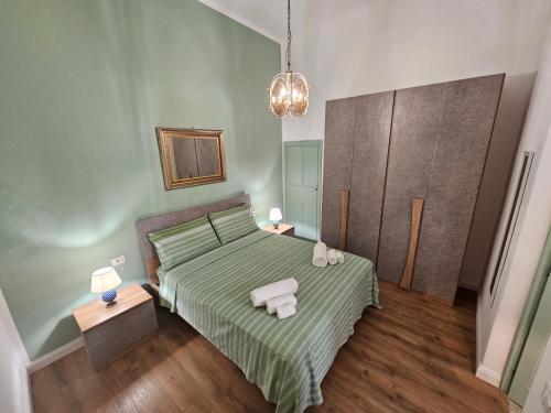 a bedroom with a bed with two towels on it at Lu Màri case vacanze in Balestrate