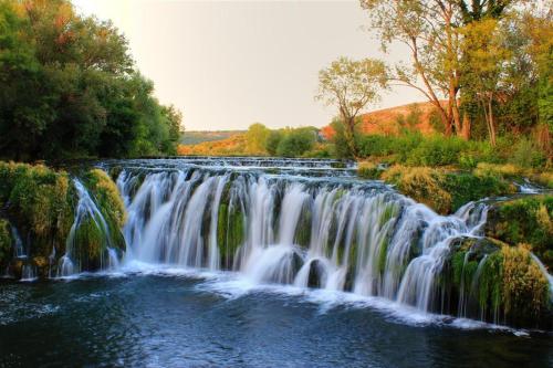 a waterfall in the middle of a river at Pansion Ljubica in Međugorje