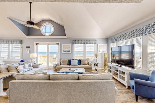 a living room with a large couch and a tv at Simplify #1F in Frisco