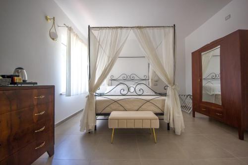 a bedroom with a bed and a dresser and a mirror at Villa la sorgente in Guardia Vomano