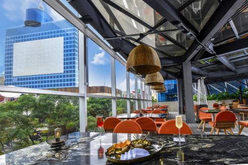 a restaurant with a view of a city at Hyatt Regency Mexico City Insurgentes WTC in Mexico City