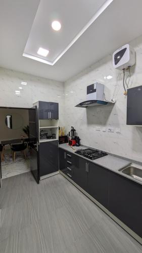a kitchen with black and white appliances and a table at Eco luxury apartments- Lekki Phase 1 in Lekki
