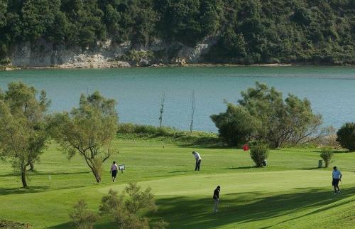 a group of people playing golf on a golf course at Apartment Aire del Mar in Liencres