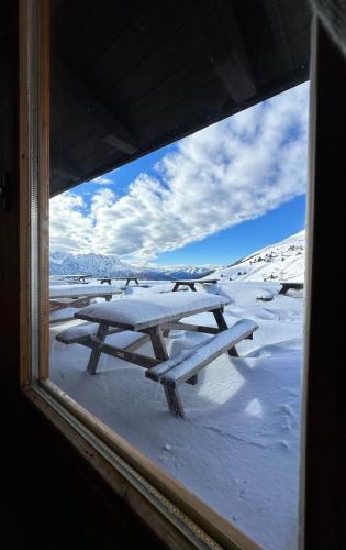 a view of a picnic table in the snow at Tonale Ski-in AlpView Studio in Passo del Tonale