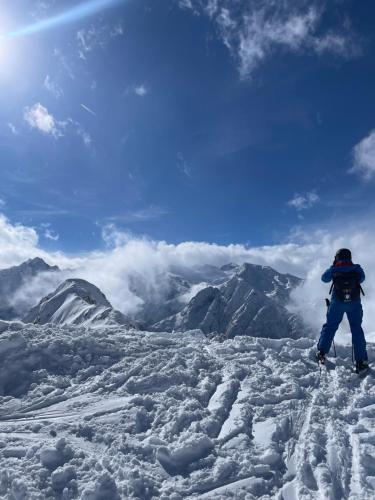a person standing on top of a snow covered mountain at Tonale Ski-in AlpView Studio in Passo del Tonale