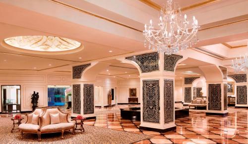 a large lobby with a chandelier and chairs at Taj Krishna in Hyderabad