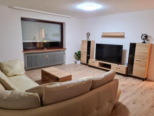 a living room with a couch and a flat screen tv at Adria Home in Veringenstadt