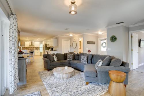 a living room with a couch and a coffee table at Pool Oasis and Fenced Yard Central Wellington Home in Wellington