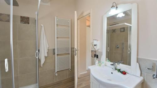a white bathroom with a sink and a shower at Nerino in Calci