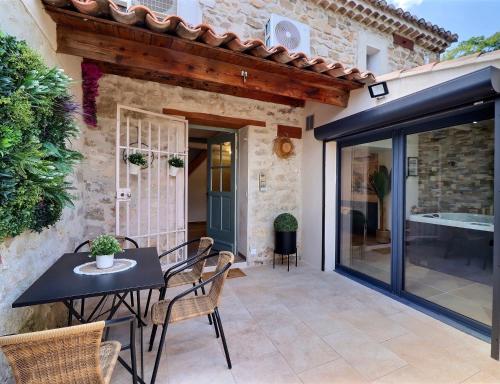 a patio with a table and chairs and a building at La Bohème Mouriès in Mouriès