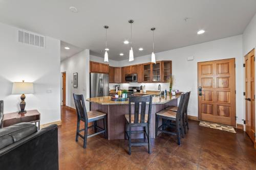 a kitchen with a large island with bar stools at 57 Robber's Roost in Moab
