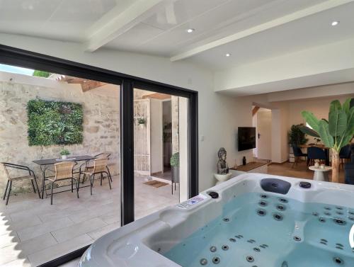 a large bath tub in a living room with a table at La Bohème Mouriès in Mouriès