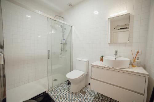 a bathroom with a toilet and a sink and a shower at Douro Panoramic Views by Vacationy in Bandeira