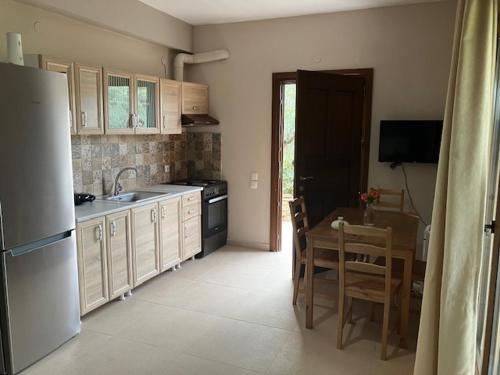 a kitchen with a table and a dining room at Κατηγιωργης ΞΕΝΩΝΑΣ ΡΕΓΓΙΝΑ 2 in Agios Georgios