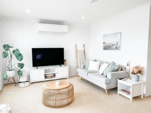 a living room with a couch and a tv at 59 Short in Nambucca Heads
