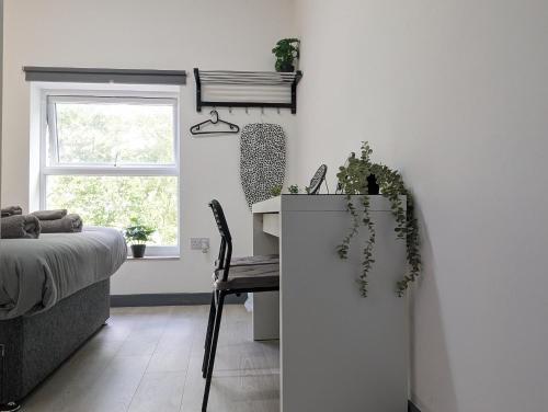 a bedroom with a desk and a bed and a window at Room Near City Centre Private Bath Free Parking in Liverpool
