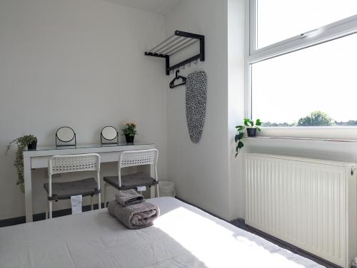 a white room with a desk and chairs and a window at Room Near City Centre Private Bath Free Parking in Liverpool