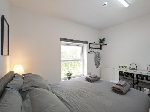 a large bed in a white room with a window at Room Near City Centre Private Bath Free Parking in Liverpool