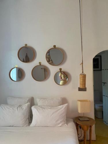 a bedroom with four mirrors on the wall at La Ferme Berbere Adult only in El Harkat