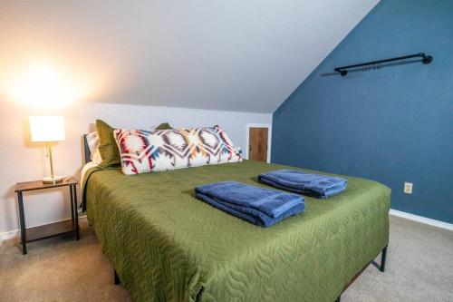 a bedroom with a bed with two pillows on it at Spacious Family Home with Hot Tub in Ellensburg