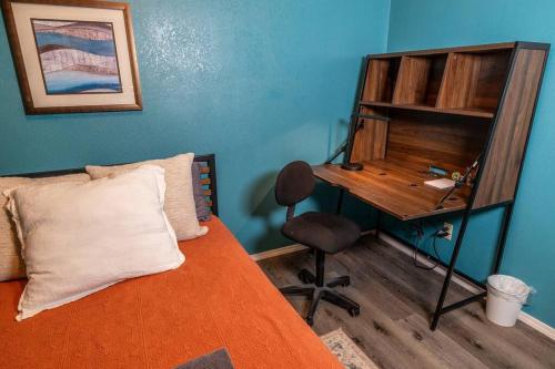 a bedroom with a bed with a desk and a chair at Spacious Family Home with Hot Tub in Ellensburg