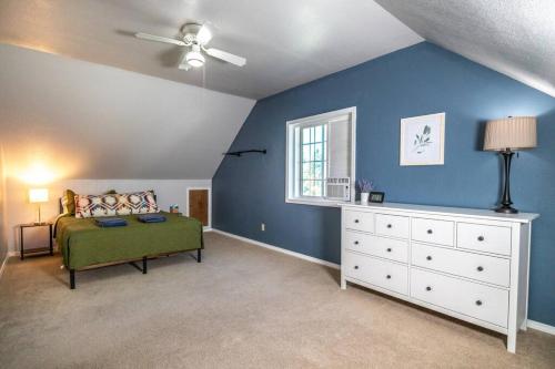 a bedroom with a bed and a white dresser at Spacious Family Home with Hot Tub in Ellensburg