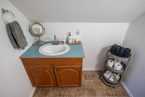 a bathroom with a sink and a mirror at Spacious Family Home with Hot Tub in Ellensburg
