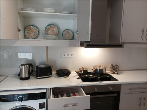 a kitchen with a stove and some pots and pans at Euphemia's Apartment in Ampavris