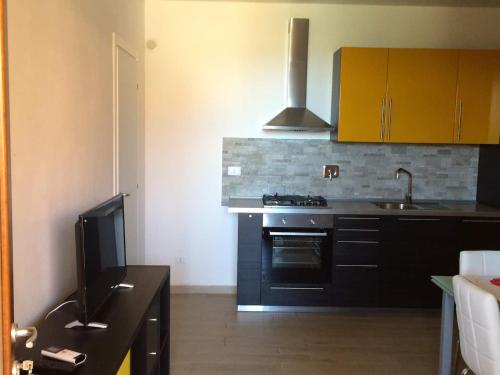 a kitchen with a black stove and a sink at Piper Residence in Puntone di Scarlino