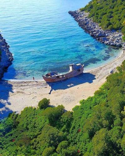 a boat sitting on the shore of a beach at Mary's House 1 in Skiros