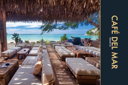 a row of chaise lounges on the beach at Luxury Apartment at a Bargain in Kamala Beach