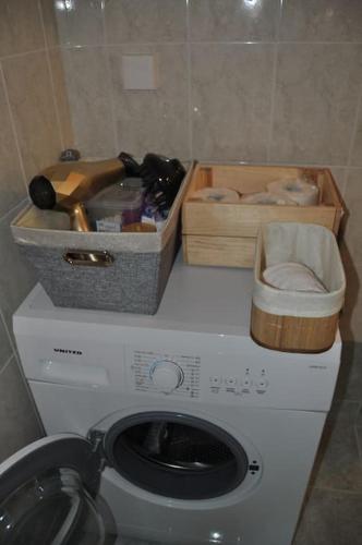 a washing machine in a bathroom with two boxes at MagnoliaHouse 2 in Preveza