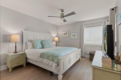 a bedroom with a bed and a ceiling fan at Shipwatch, Unit 113 - 1524 Wood Avenue in East End