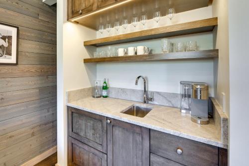 a kitchen with wooden cabinets and a sink at Sun Valley Condo with Furnished Patio Near Skiing! in Sun Valley