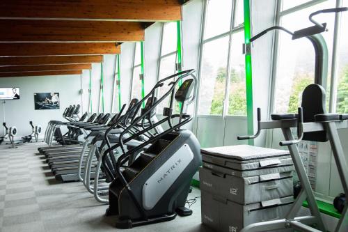 a gym with a row of treadms and elliptical machines at Broad Larch Lodge in Bowness-on-Windermere