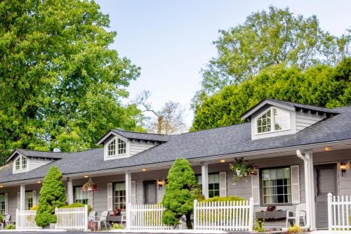 a white house with a gray roof at Azalea Garden Inn in Blowing Rock