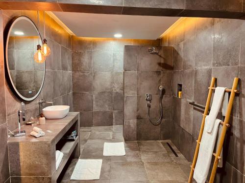 a bathroom with a sink and a shower at Le Patio in Lomé