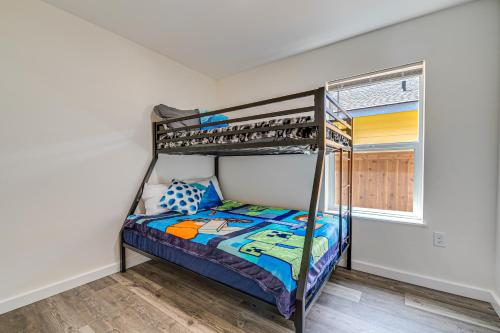 a bedroom with a bunk bed and a window at Charming Westport Abode with Hot Tub, Deck and Yard! in Westport